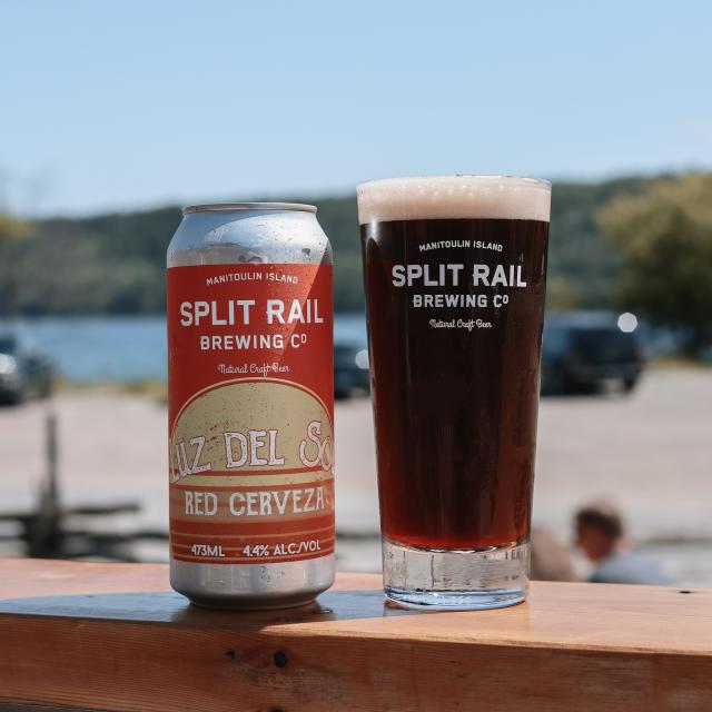 A can of Split Rail Brewing's Luz del Sol beer beside a glass of beer